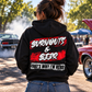 Woman wearing black Burnouts & Beer That's Why I'm Here racing hoodie at a car show by Car Chix