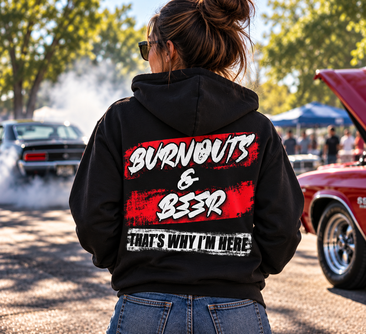 Woman wearing black Burnouts & Beer That's Why I'm Here racing hoodie at a car show by Car Chix