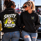 Women wearing black Safety Third hoodie at a motorsports event with muscle car by Car Chix