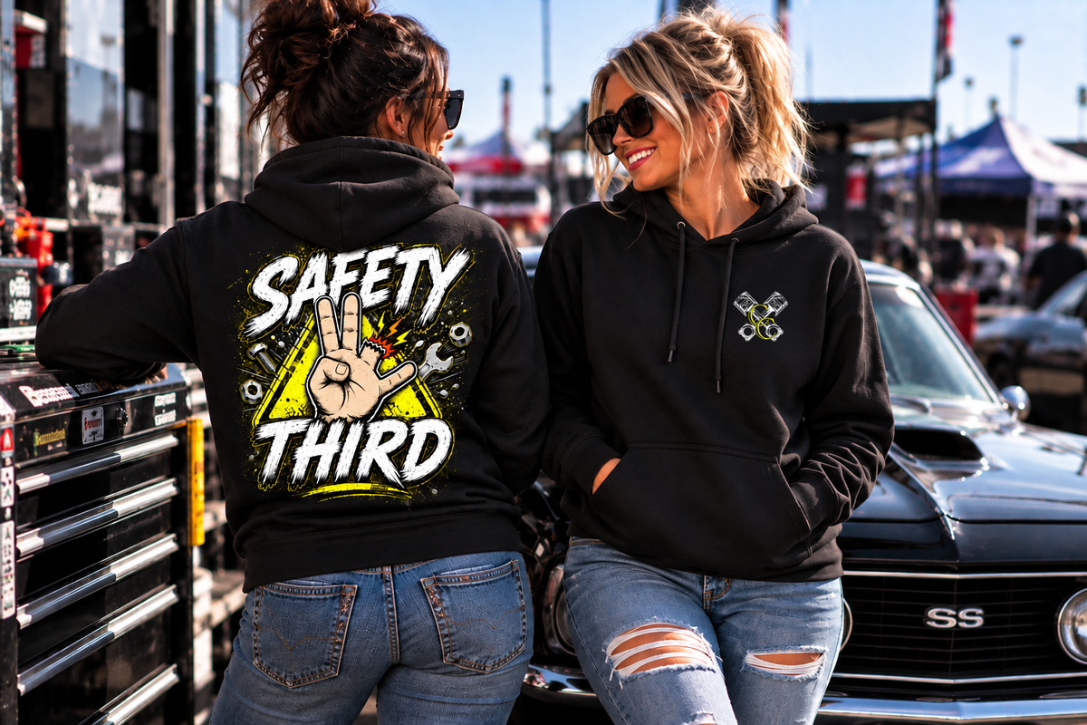 Women wearing black Safety Third hoodie at a motorsports event with muscle car by Car Chix