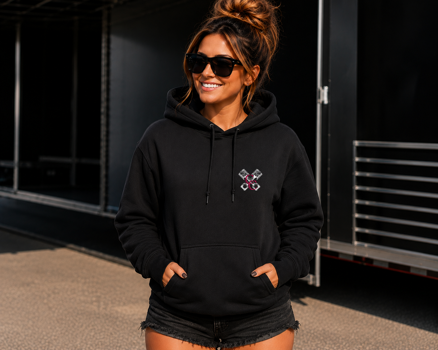 Front of black My Dog & I Talk Sh*t About You hoodie with neon pink Car Chix piston chest logo