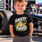 Toddler boy wearing black Safety Third racing T-shirt at the racetrack by Car Chix