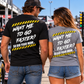 Man and woman wearing Want Me to Go Faster So Did Your Mom racing shirts at the racetrack