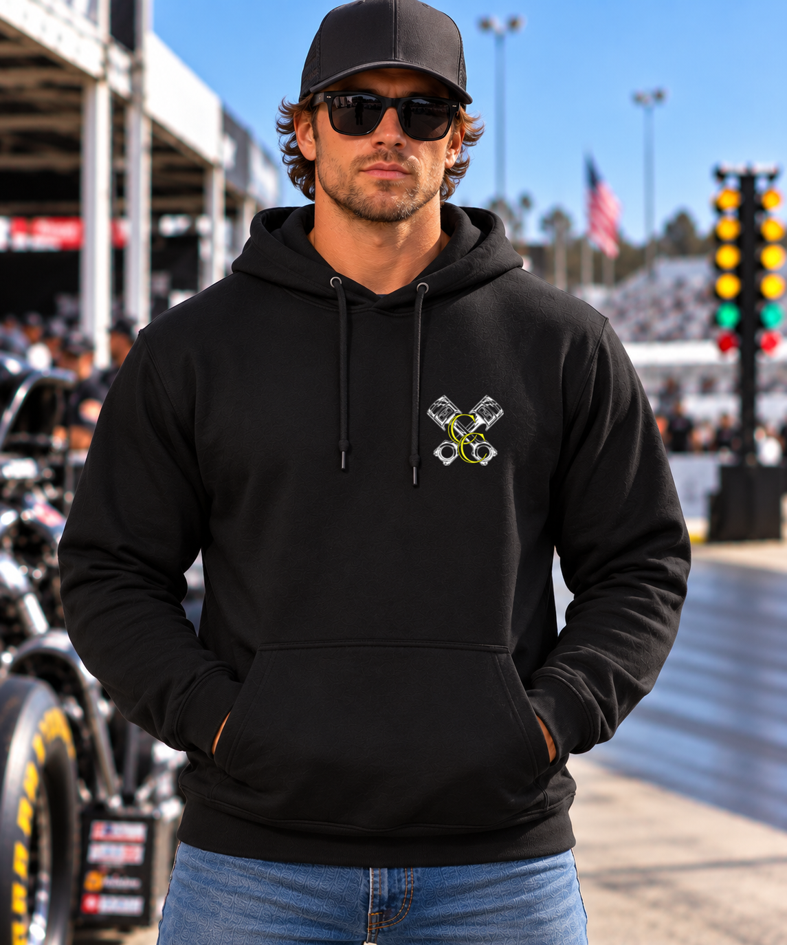 Front view of man wearing black Want Me to Go Faster racing hoodie with Car Chix left chest logo
