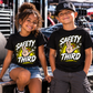 Boy and girl wearing black Safety Third youth racing T-shirts by Car Chix