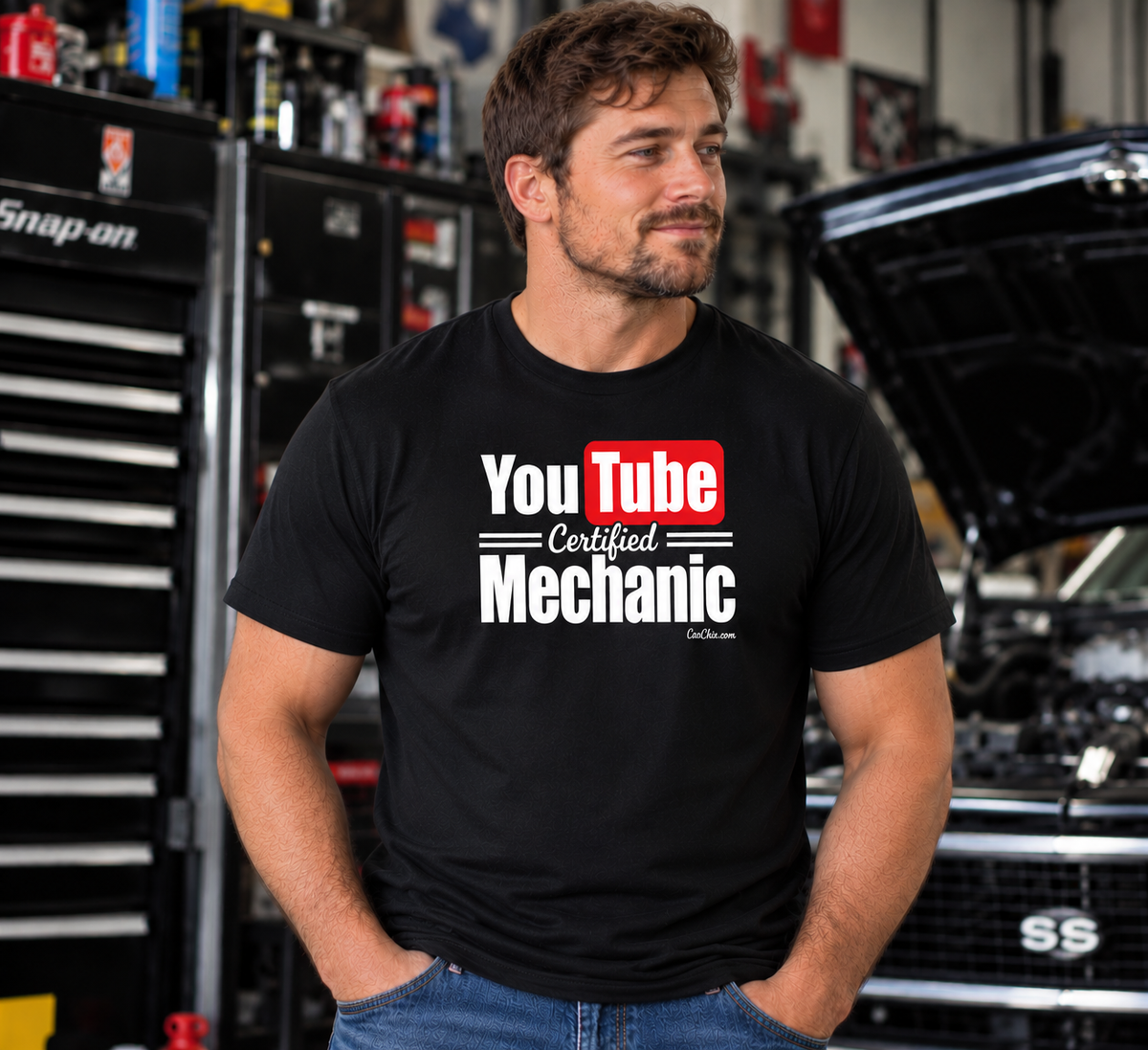 Man wearing black YouTube Certified Mechanic T-shirt with front graphic in an automotive garage by Car Chix