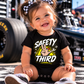 Baby girl wearing black Safety Third racing and mechanic bodysuit by Car Chix