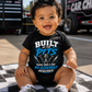Baby girl wearing Built in the Pits Thanks Mom and Dad infant racing bodysuit at the racetrack