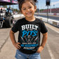 Toddler girl wearing Built in the Pits Thanks Mom and Dad kids racing tee at the racetrack