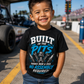 Toddler boy wearing Built in the Pits Thanks Mom and Dad racing T-shirt at a drag strip