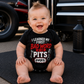 Baby boy wearing I Learned My First Bad Word in the Pits racing onesie