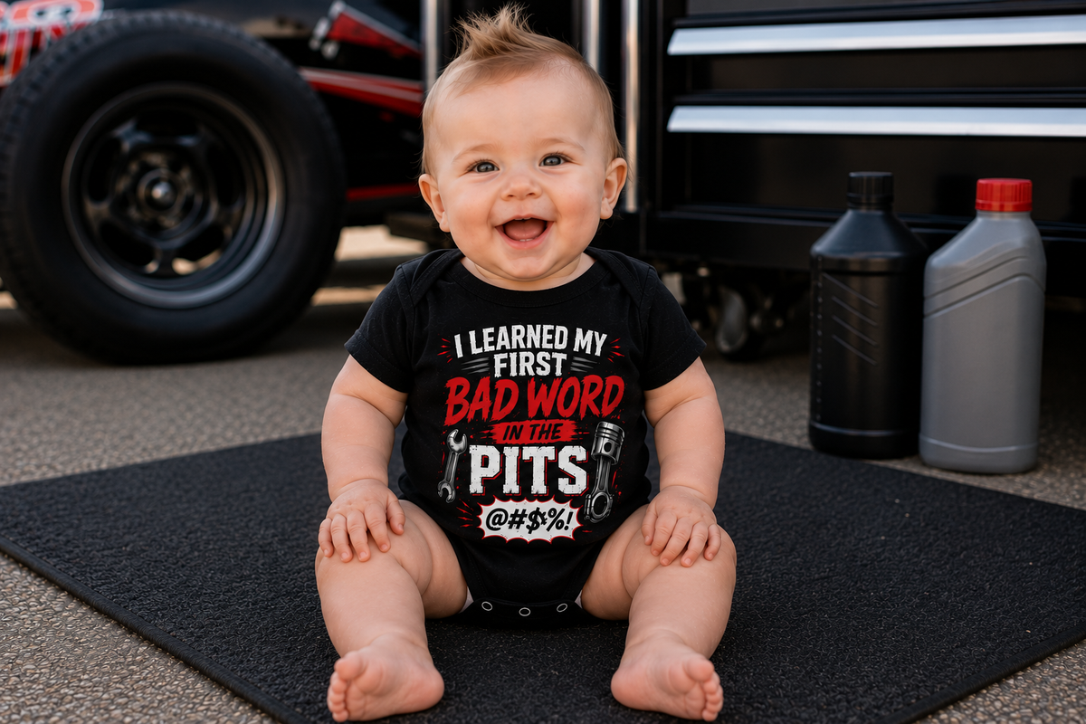 Baby boy wearing I Learned My First Bad Word in the Pits racing onesie