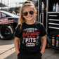Girl wearing I Learned My First Bad Word in the Pits kids racing tee in the pits