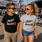 Kids wearing Just Send It youth racing T-shirts at a motorsports event