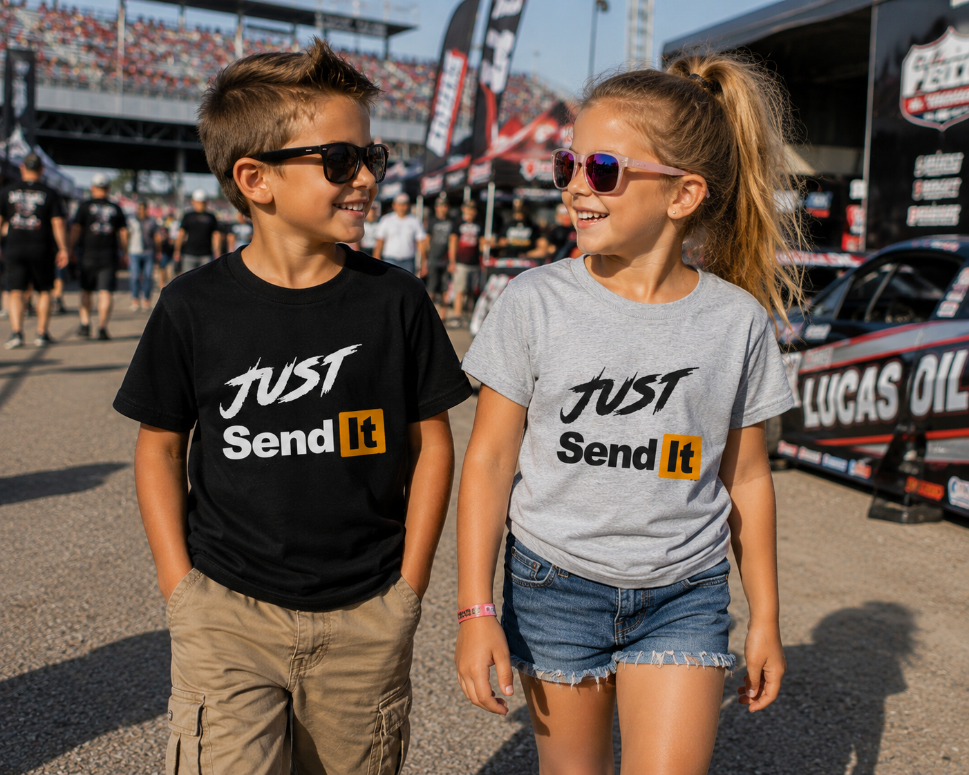 Kids wearing Just Send It youth racing T-shirts at a motorsports event