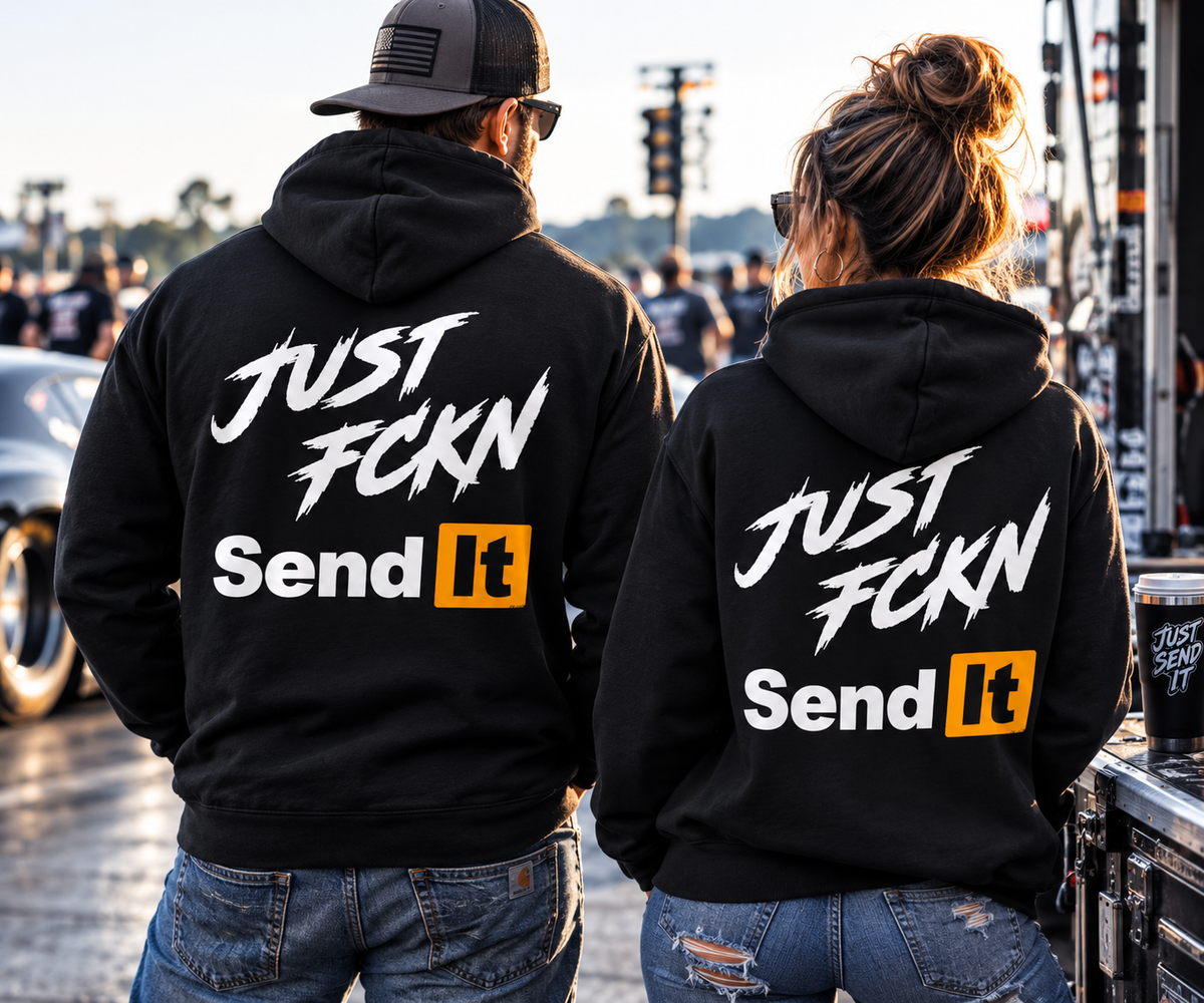 Man and woman wearing black Just Fckn Send It racing hoodies at the drag strip