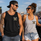 Man and woman wearing Just Fckn Send It racing tank tops at the drag strip