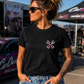 Woman wearing black My Dog & I Talk Sh*t About You T-shirt with neon pink Prodigy design by Car Chix