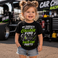 Toddler girl wearing College Fund Race Car Parts kids racing tee in the pits