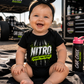 Smiling baby wearing Nitro Cheaper Than Therapy drag racing onesie by Car Chix