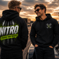 Two men wearing Nitro Cheaper Than Therapy hoodies at the racetrack