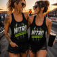 Two women wearing matching Nitro Cheaper Than Therapy racerback tanks at the racetrack
