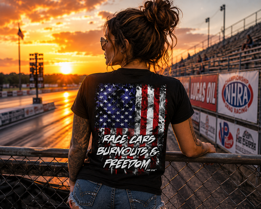 Woman wearing black Race Cars Burnouts & Freedom racing T-shirt at sunset by Car Chix