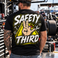 Man wearing black Safety Third T-shirt with neon yellow racing and mechanic design by Car Chix