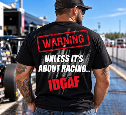 Man wearing black Car Chix Unless It's About Racing IDGAF T-shirt featuring large red and white warning graphic on the back at a drag racing event.