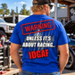 Blonde man wearing blue Car Chix Unless It's About Racing IDGAF T-shirt with bold red and white back graphic at an automotive garage.